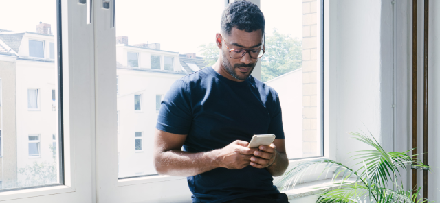 Man using phone by the window