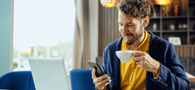 Man smiling while sipping tea